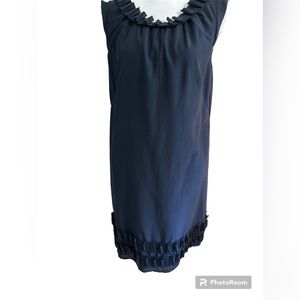 Loft navy blue sleeveless dress with pleated ruffle at neck and hem. Back hi bow